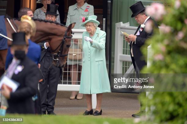 Queen Elizabeth II watches as horses are led into the parade ring during Royal Ascot 2021 at Ascot Racecourse on June 19, 2021 in Ascot, England.