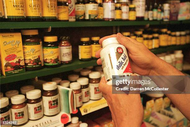 Customer looks at vitamins July 10, 2001 at Green Street Natural Foods in Melrose, MA. Alternative health products have become increasingly popular...