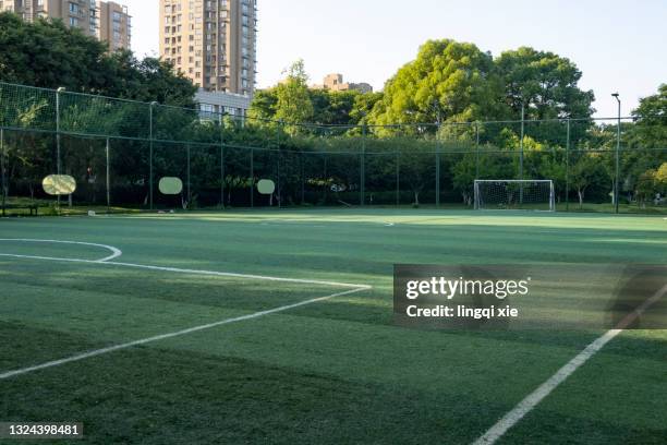 amateur football field surrounded by green trees - sports field fence stock pictures, royalty-free photos & images