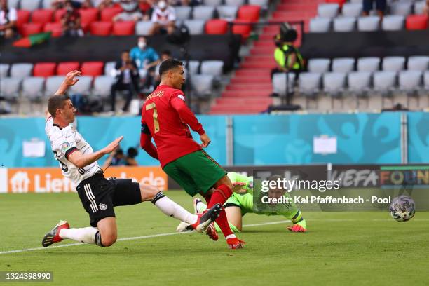 Cristiano Ronaldo of Portugal scores their side's first goal past Manuel Neuer of Germany whilst under pressure from Robin Gosens of Germany during...