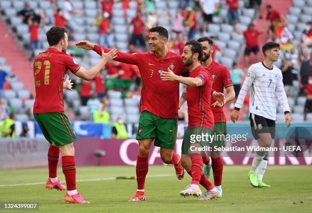 Cristiano Ronaldo of Portugal celebrates with Diogo Jota and Bernardo Silva after scoring their side's first goal during the UEFA Euro 2020...