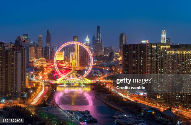 ferris wheel, a landmark building in tianjin, china - circular business district stock pictures, royalty-free photos & images