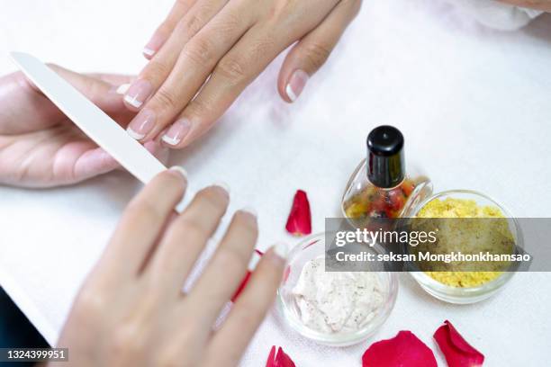 brushing the nail for manicure - french manicure stock pictures, royalty-free photos & images