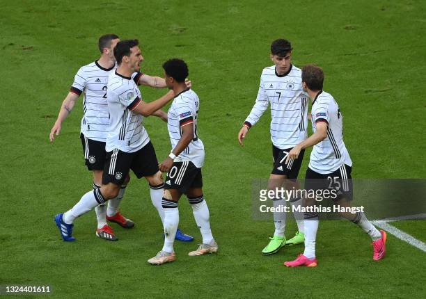 Kai Havertz of Germany celebrates with team mates after their side's first goal credited as an own goal scored by Ruben Dias of Portugal during the...
