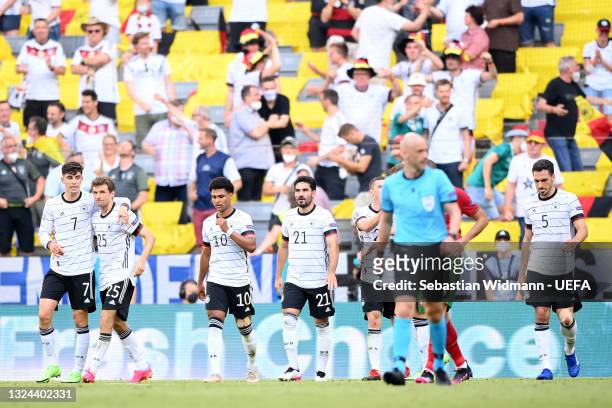 Kai Havertz of Germany celebrates with Thomas Mueller after their side's first goal credited as and own goal scored by Ruben Dias of Portugal during...