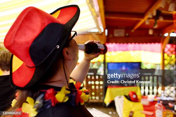 Fan is drinkiing beer during the UEFA EURO 2020 match between Germany and Portugal at garden plot Hohe Birk on June 19, 2021 in Essen, Germany. Due...