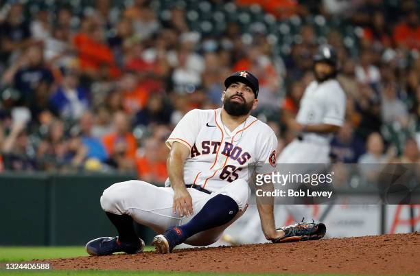 Jose Urquidy of the Houston Astros sits on the mound after being almost hit by a ball up the middle against the Chicago White Sox at Minute Maid Park...
