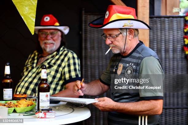 Fans bet on the UEFA EURO 2020 match between Germany and Portugal at garden plot Hohe Birk on June 19, 2021 in Essen, Germany. Due to Covid-19...