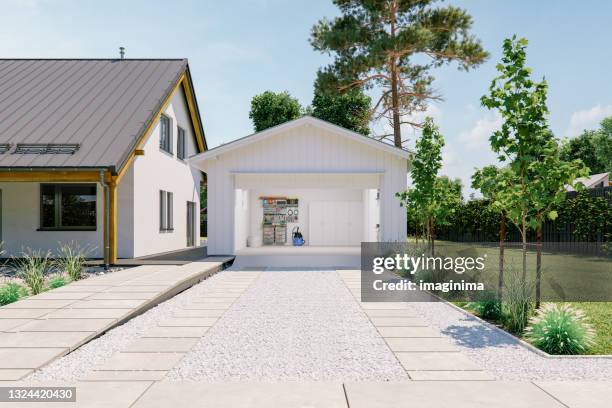 open garage with concrete driveway - carport stockfoto's en -beelden