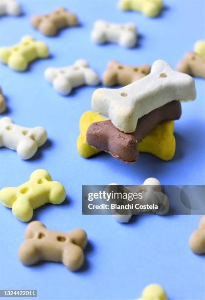 dog bones on blue background - dog bone biscuit stock pictures, royalty-free photos & images