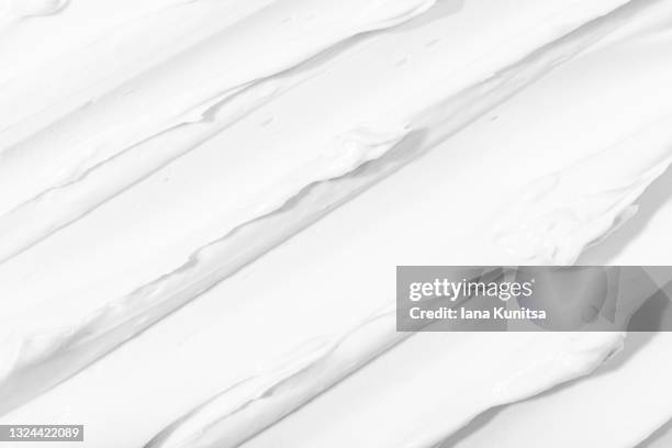 texture of white face cream is smeared. cosmetic products for makeup and skin care. - shaving cream stock pictures, royalty-free photos & images