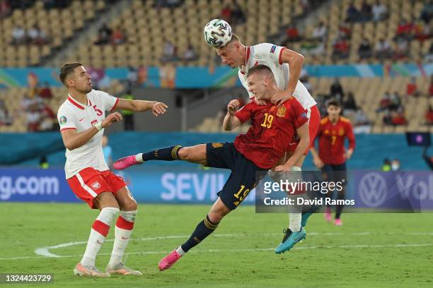 Kamil Glik of Poland competes for a header with whilst under pressure from Dani Olmo of Spain during the UEFA Euro 2020 Championship Group E match...