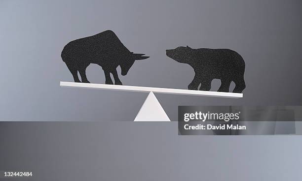 balance between a bull and a bear. - bull bear stock-fotos und bilder