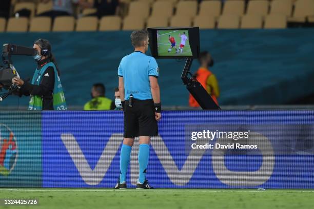 Match Referee, Daniele Orsato goes to the VAR screen to review a potential penalty for Spain during the UEFA Euro 2020 Championship Group E match...
