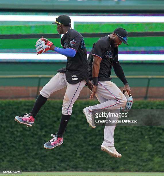 Jazz Chisholm Jr. #2 and Starling Marte of the Miami Marlins celebrate their team's win over the Chicago Cubs at Wrigley Field on June 19, 2021 in...