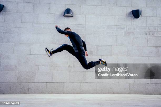 man athlete jumping during exercising - acrobatic activity stock pictures, royalty-free photos & images