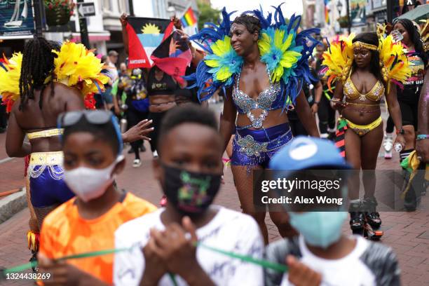 La'Verne Webb of Soul2Sole Bounce Fitness wears a carnival costume as she participates in a parade to celebrate Juneteenth on June 19, 2021 in...