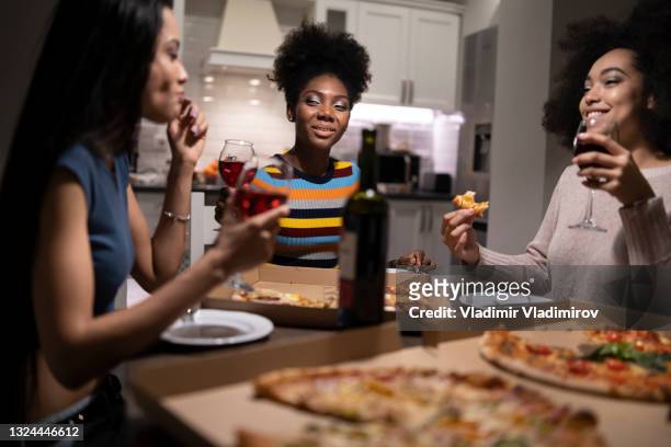 three young beautiful multi-ethnic women having fun at home party - wine home delivery stock pictures, royalty-free photos & images