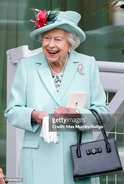 Queen Elizabeth II holds a racecard as she attends day 5 of Royal Ascot at Ascot Racecourse on June 19, 2021 in Ascot, England.
