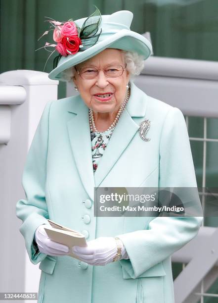 Queen Elizabeth II holds a racecard as she attends day 5 of Royal Ascot at Ascot Racecourse on June 19, 2021 in Ascot, England.