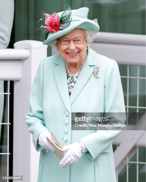 Queen Elizabeth II holds a racecard as she attends day 5 of Royal Ascot at Ascot Racecourse on June 19, 2021 in Ascot, England.