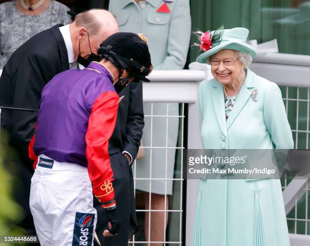 Jockey Frankie Dettori bows to Queen Elizabeth II before riding her horse 'Reach for the Moon' into second place in The Chesham Stakes on day 5 of...