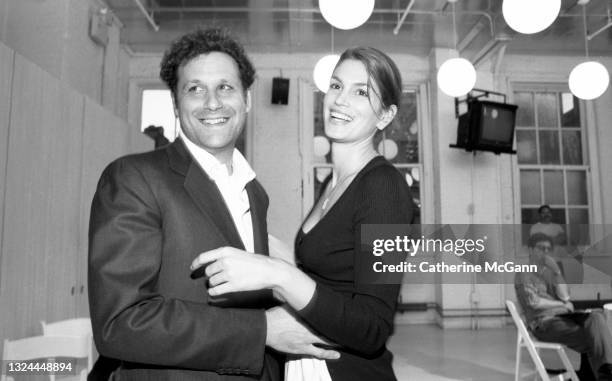 Fashion designer Isaac Mizrahi and supermodel Cindy Crawford pose for a photo at Mizrahi"u2019s Soho showroom in July 1996 in New York City, New York.