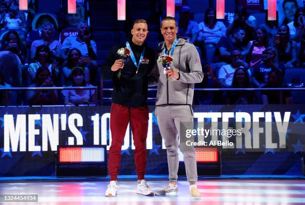 Caeleb Dressel and Tom Shields react during the Men’s 100m butterfly medal ceremony during Day Seven of the 2021 U.S. Olympic Team Swimming Trials at...
