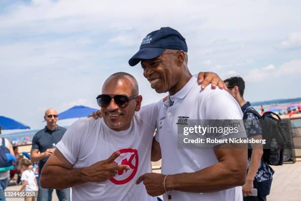 New York City Democratic Party mayoral candidate Eric Adams poses for a photo with a beachgoer as he campaigns during the new Federal holiday...