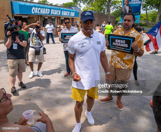 New York City Democratic Party mayoral candidate Eric Adams speaks to beachgoers as he campaigns during the new Federal holiday Juneteenth at Orchard...