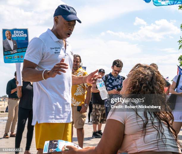 New York City Democratic Party mayoral candidate Eric Adams speaks to a beachgoer as he campaigns during the new Federal holiday Juneteenth at...