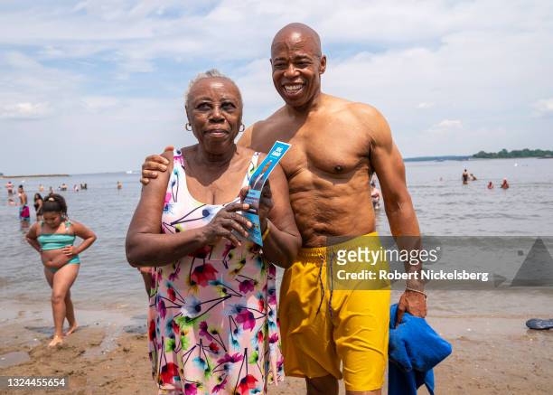 New York City Democratic Party mayoral candidate Eric Adams poses for a photo with a beachgoer as he campaigns during the new Federal holiday...