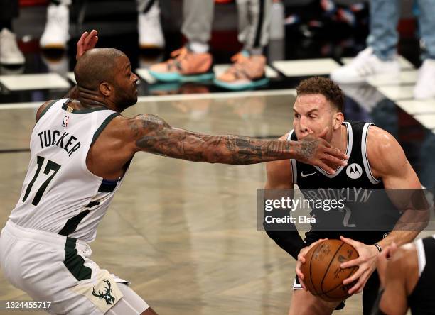 Blake Griffin of the Brooklyn Nets is fouled by P.J. Tucker of the Milwaukee Bucks in the first half during game seven of the Eastern Conference...