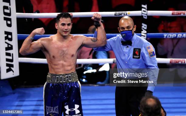 Undefeated junior welterweight boxer Lindolfo Delgado of Mexico has his arm raised after defeating Salvador Briceno in an eight-round bout at Virgin...