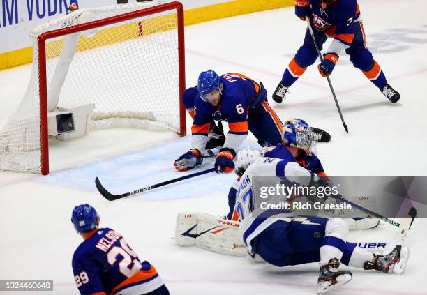 Ryan Pulock of the New York Islanders blocks a shot by Ryan McDonagh of the Tampa Bay Lightning during the third period in Game Four of the Stanley...