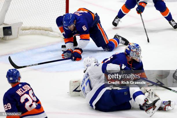 Ryan Pulock of the New York Islanders blocks a shot by Ryan McDonagh of the Tampa Bay Lightning during the third period in Game Four of the Stanley...