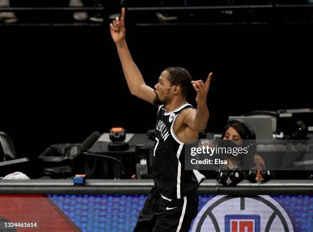 Kevin Durant of the Brooklyn Nets celebrates after he made a shot to tie the game and force overtime in the final seconds of the fourth quarter...