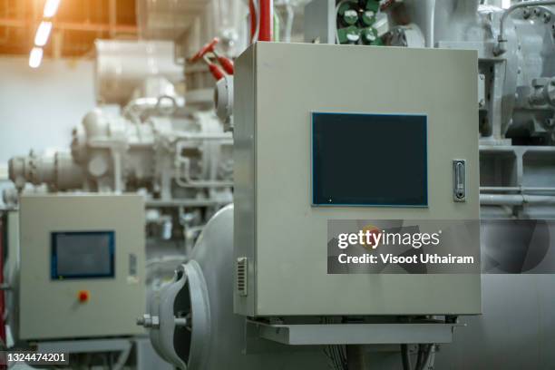boilers and equipment in a boiler room at industrial workshop factory. - pump schoen stockfoto's en -beelden