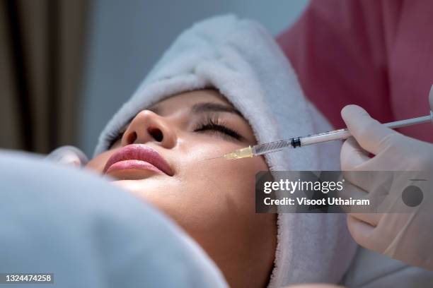 young woman has a botox injections,cosmetology and skin care,plastic surgery clinic. - botox injections stock pictures, royalty-free photos & images