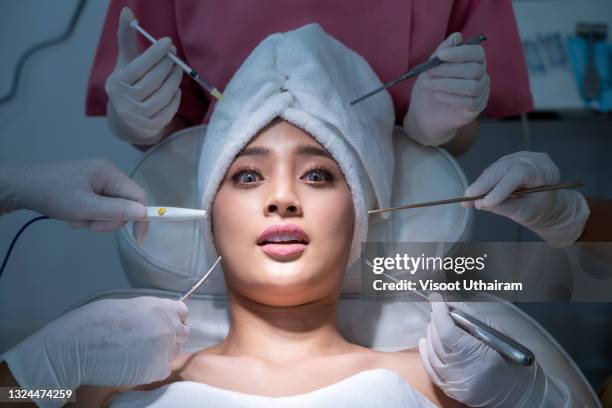 conceptual beauty and cosmetology image of the hands of several beauticians holding their respective equipment. - anesthesia mask stock-fotos und bilder