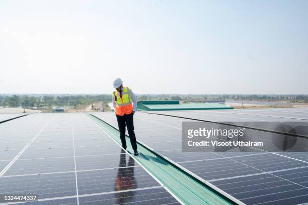 engineering of solar industry working on solar rooftop at industrial factory. - roof inspector stock pictures, royalty-free photos & images