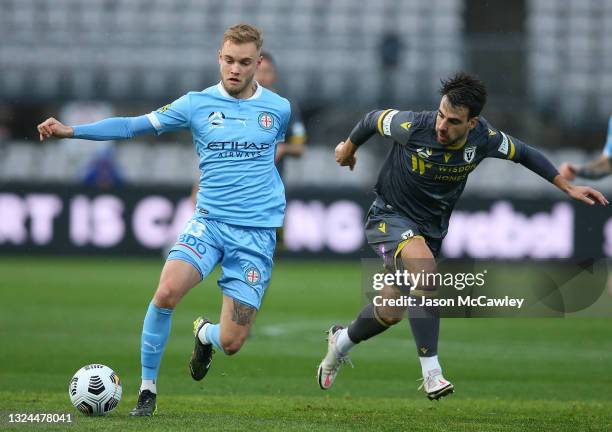 Nathaniel Atkinson of Melbourne City is chased by Benat Etxebarria of Macarthur FC during the A-League Semi-Final match between Melbourne City and...