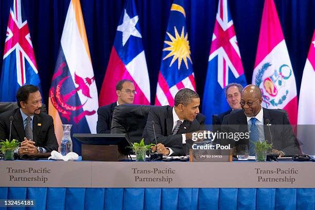 President Barack Obama talks to US Trade Representative Ron Kirk as he meets with Trans-Pacific Partnership leaders during the APEC CEO Summit at the...