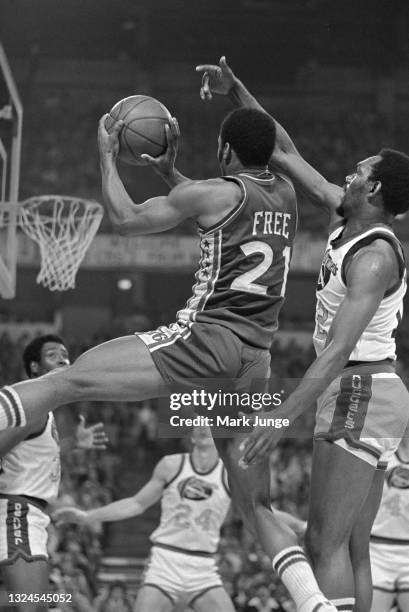 Philadelphia 76ers guard World B. Free drives past Denver Nuggets guard Ted McClain for a layup during an NBA basketball game at McNichols Arena on...