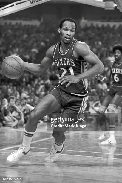 Philadelphia 76ers guard World B. Free dribbles the ball away from the basket during an NBA basketball game against the Denver Nuggets at McNichols...