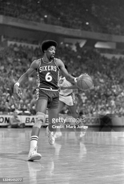 Philadelphia 76ers forward Julius Erving dribbles the ball during an NBA basketball game against the Denver Nuggets at McNichols Arena on January 30,...