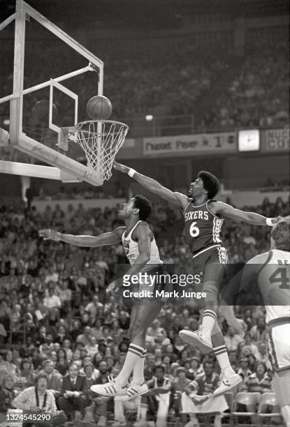 Philadelphia 76ers forward Julius Erving attempts to block a layup by Denver Nuggets guard Jim Price during an NBA basketball game at McNichols Arena...