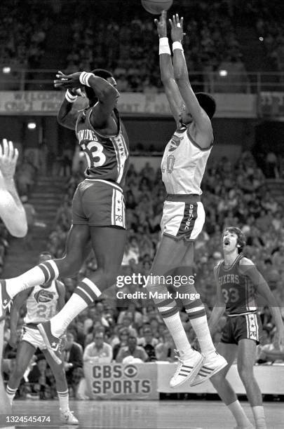 Philadelphia 76ers center Darryl Dawkins confronts Denver Nuggets center Marvin Webster as Webster shoots over him during an NBA basketball game at...