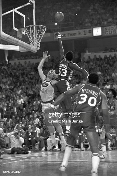 Philadelphia 76ers center Darryl Dawkins blocks a shot by Denver Nuggets center Dan Issel during an NBA basketball game at McNichols Arena on January...