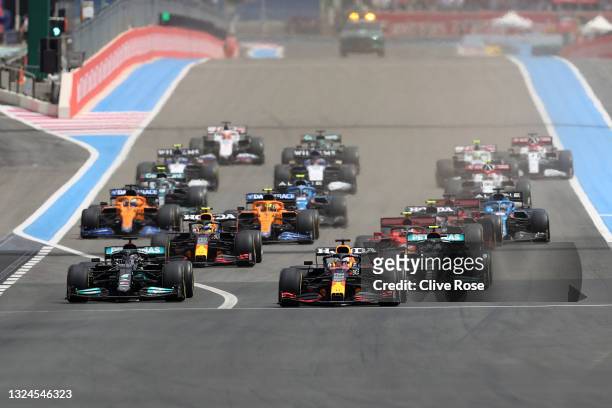 Max Verstappen of Netherlands and Red Bull Racing leads Lewis Hamilton of Great Britain into the first corner at the start of the F1 Grand Prix of...